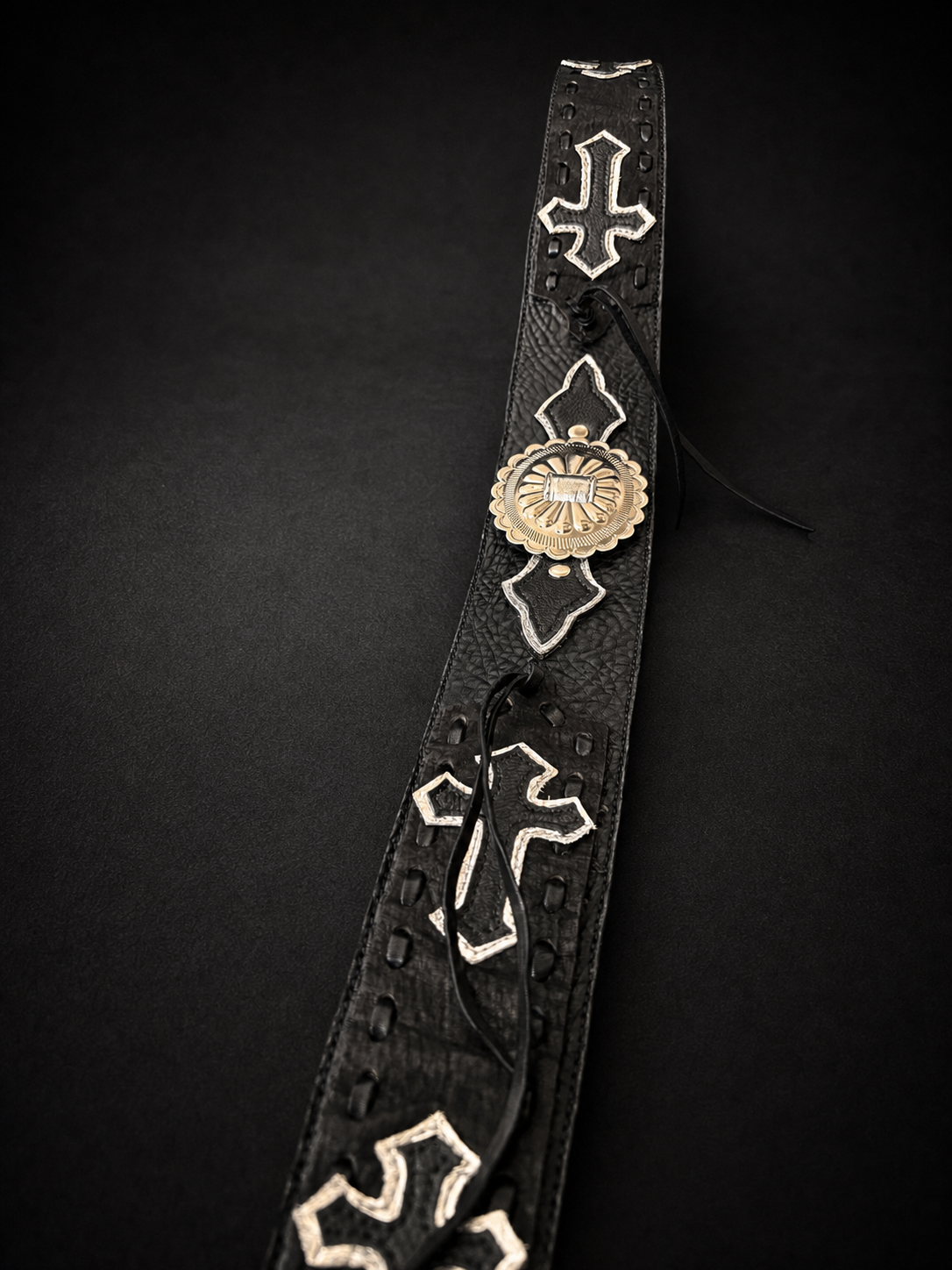 Close-up of black cowhide leather texture on ANJIN guitar strap from Japan