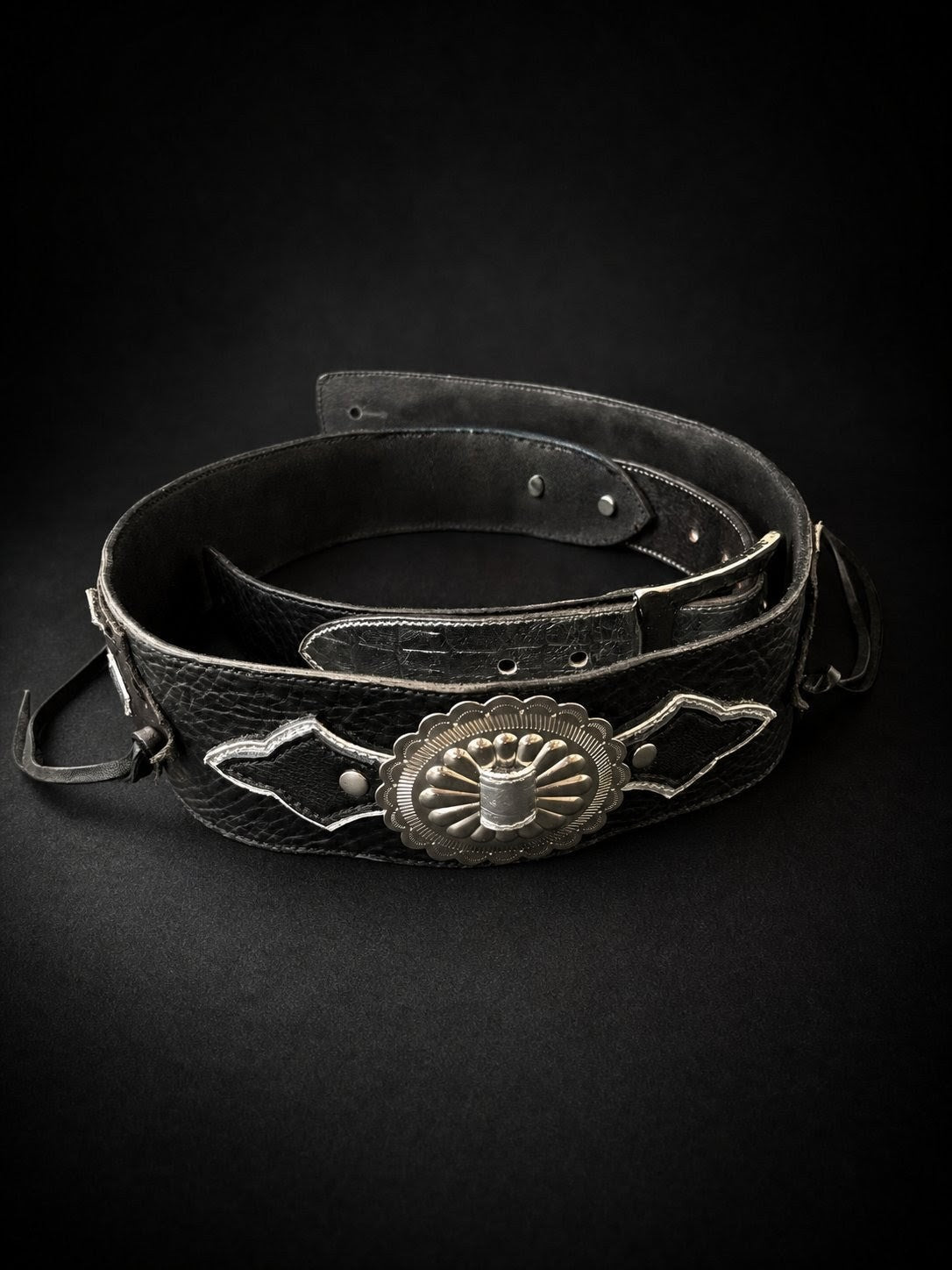 Side view of ANJIN black leather guitar strap showing width and stitching