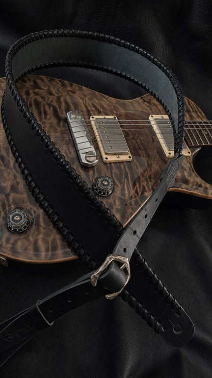 NINJA WIDE handmade leather guitar strap worn on electric guitar on stage, black cowhide